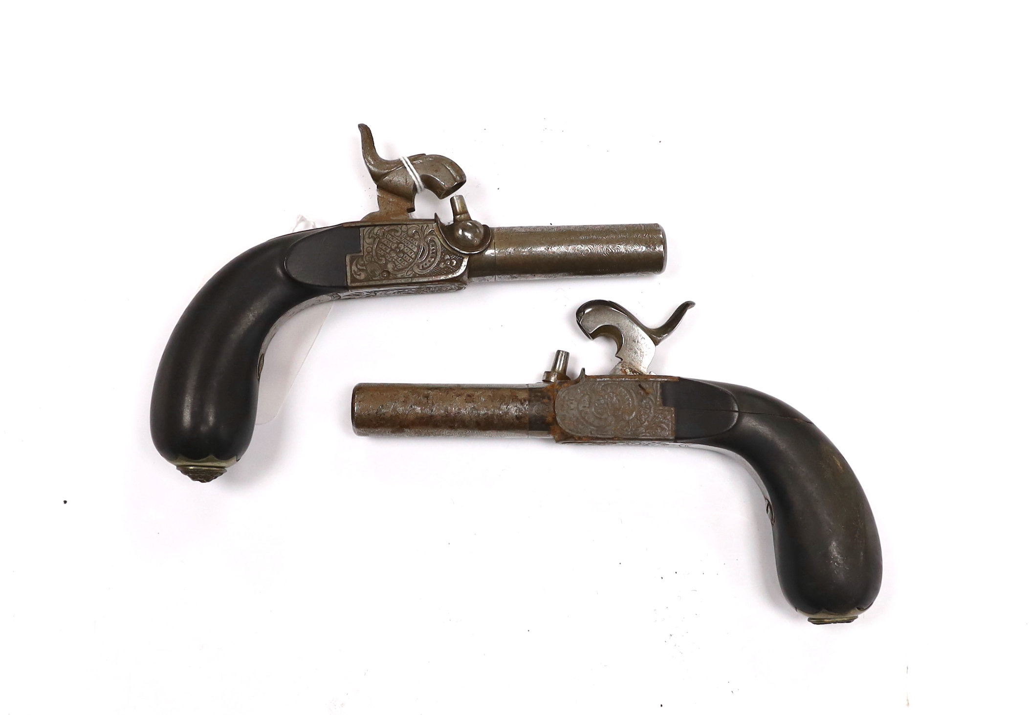A pair of 19th century box lock, percussion pistols, with turn off Damascus twist barrels, engraved frames, folding triggers, and rounded ebony grips fitted with hinged butt cap lids, barrels 4.8cm